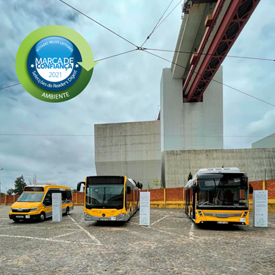 Fotografia do interior da Estação de Santo Amaro, por baixo da Ponte 25 de Abril, onde aparecem 3 autocarros e imagem do Selo Marca Confiança Ambiente 2021